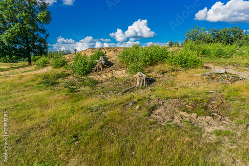 moorland grass and sandy hill landscape with road