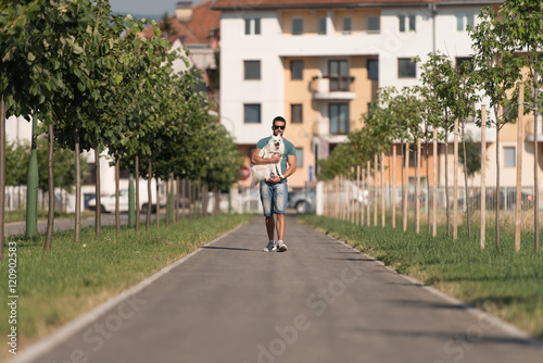 Young Man And Dog Walking On Park © Jale Ibrak