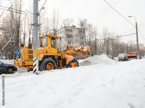 tractor clears snow in the winter