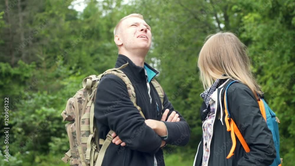 Couple standing in the forest and pointing on something while talking
Couple standing in the forest and pointing on something while talking