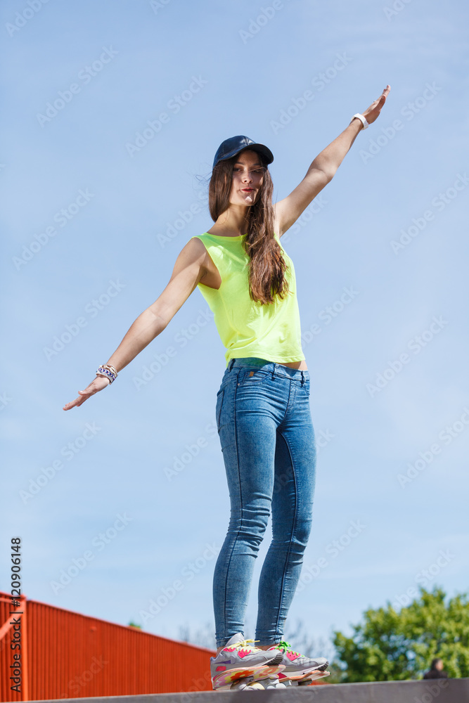 Teen girl skater riding skateboard on street. Teen girl skater riding skateboard on street.