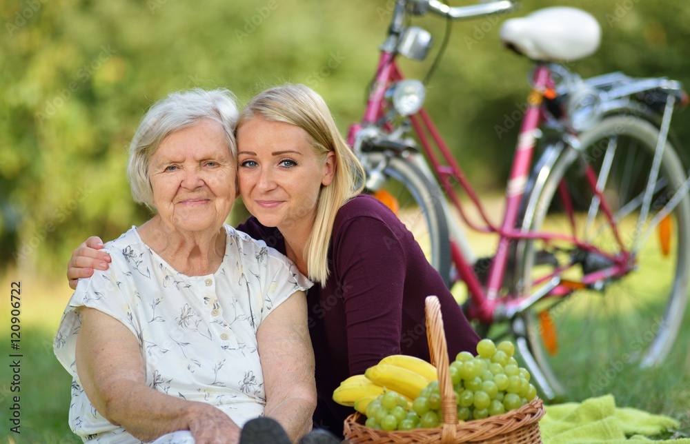 Elderly woman and young woman at the picnic.