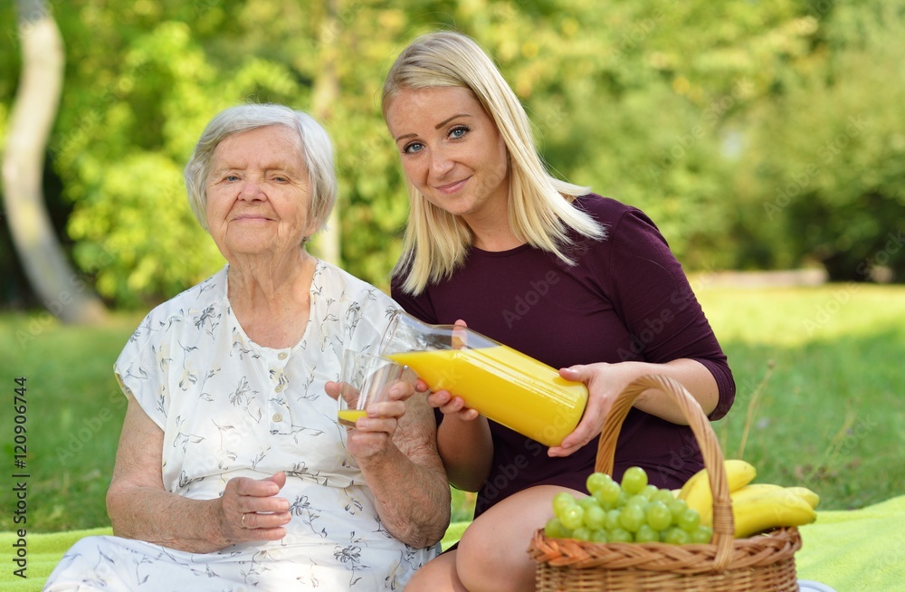Elderly woman and young woman at the picnic.