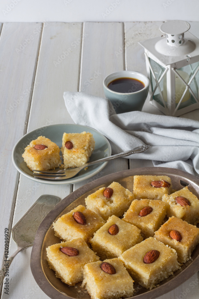 Homemade Basbousa with Coffee on White Wooden Table Vertical with Copy Space Homemade Basbousa with Coffee on White Wooden Table Vertical with Copy Space