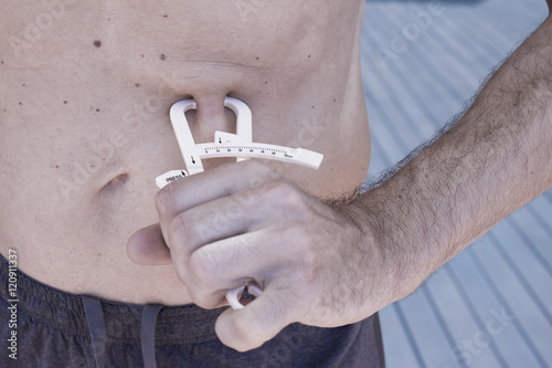 Man measuring body contouring photo