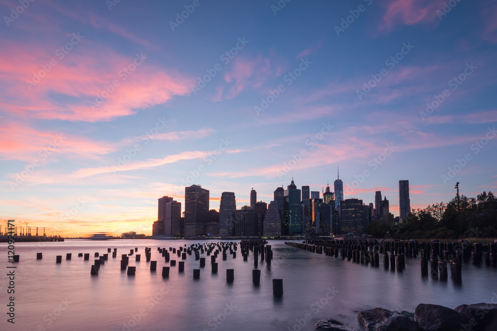 Golden hour in Brooklyn New York looking at a Brooklyn dock on the left and lower Manhattan on the right