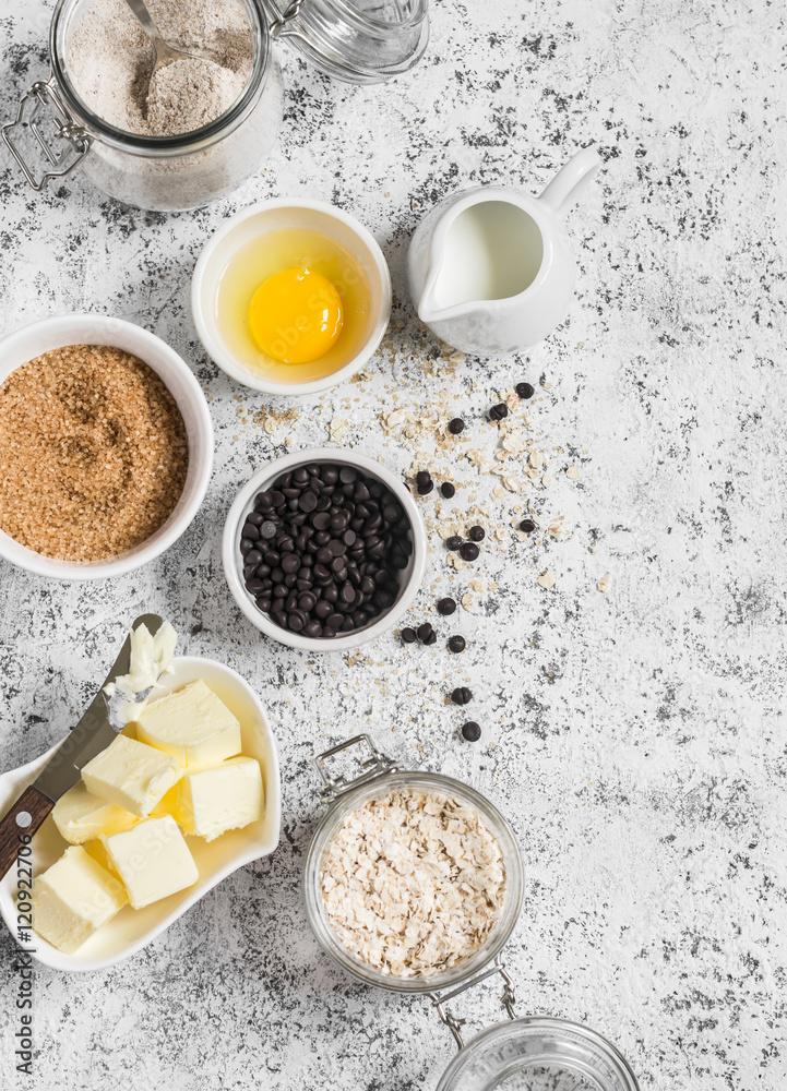 Baking background. Flour, sugar, butter, rolled oats, eggs, chocolate chips on a light background. Baking ingredients Baking background. Flour, sugar, butter, rolled oats, eggs, chocolate chips on a light background. Baking ingredients