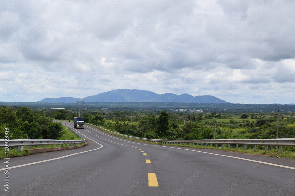 Naklejka premium asphalt road lead to the mountain