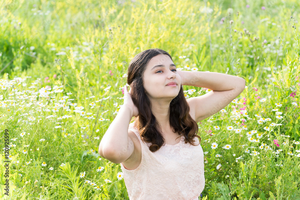 Teenage girl resting on flower meadow Teenage girl resting on flower meadow
