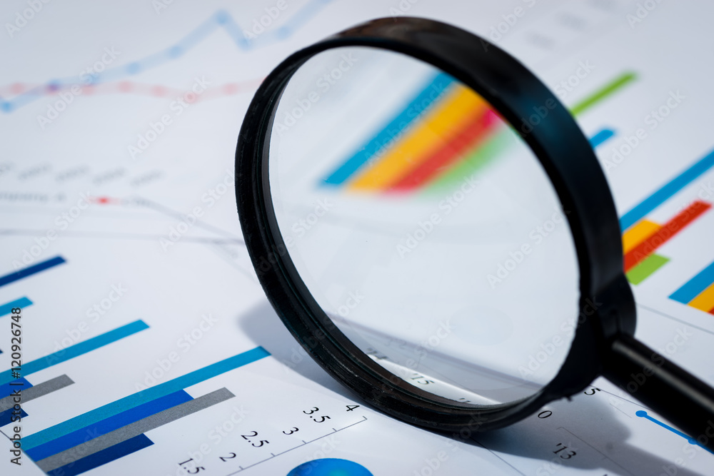 Business Analysis Image - magnifying glass on graphs and spreadsheet Business Analysis Image - magnifying glass on graphs and spreadsheet