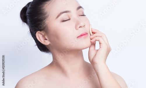 Woman applying foundation with sponge