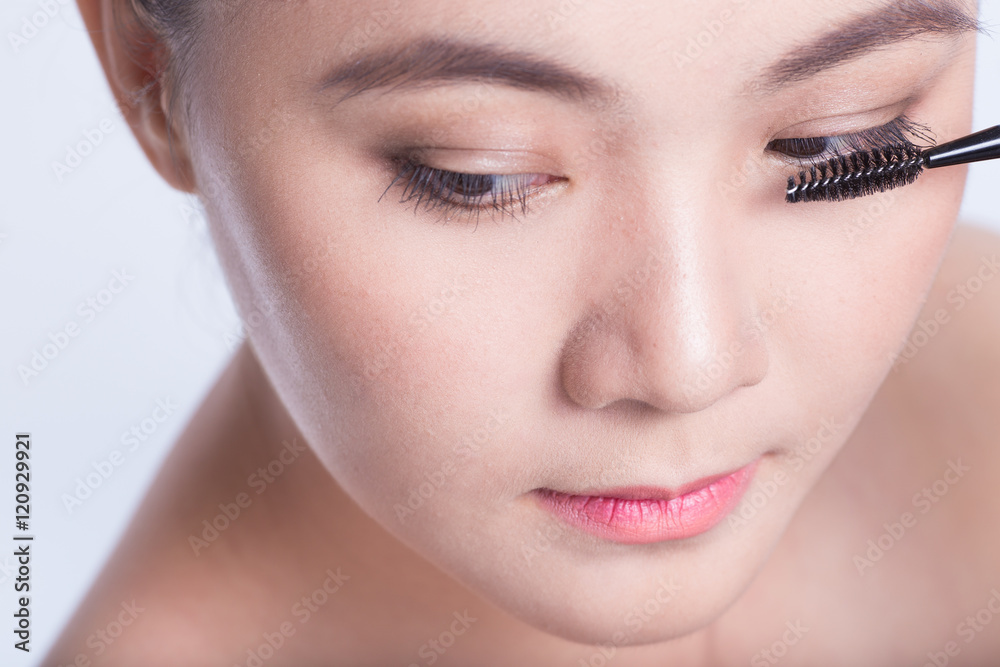 Beauty shot of woman holding the makeup brush Beauty shot of woman holding the makeup brush