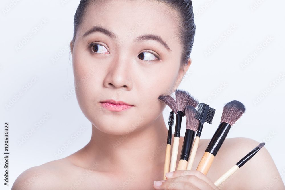 Beauty shot of woman holding the makeup brush Beauty shot of woman holding the makeup brush