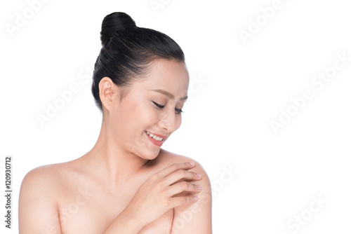 Beautiful asian girl stroking her healthy skin isolated on white