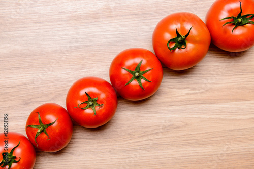 red tomatoes on wooden ground