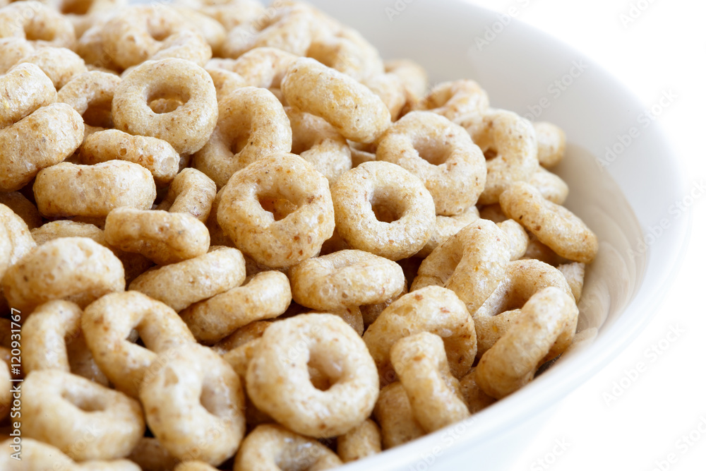 Detail of bowl of honey cheerios on white. Detail of bowl of honey cheerios on white.
