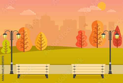 Beautiful autumn park with benches, yellow and orange trees and city views. Evening park at sunset.