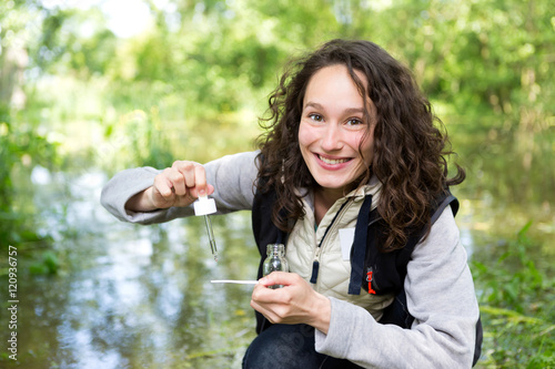 Young attractive biologist woman working on water analysis photo