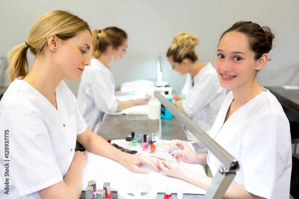 Young attractive beautician students practising during courses Young attractive beautician students practising during courses