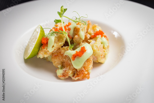 shrimp tempura with roe on white plate, restaurant
