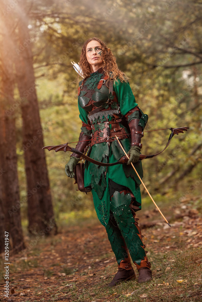 Elf woman in green leather armor with the bow and arrows on the