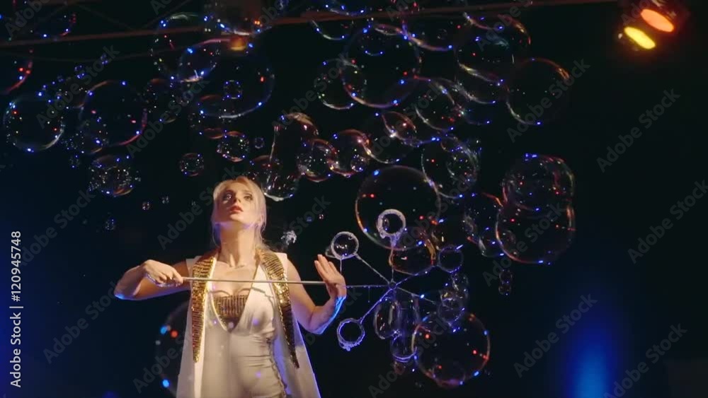 The woman the actor is turned and sprays big soap bubbles by means of forms. The woman the actor is turned and sprays big soap bubbles by means of forms.