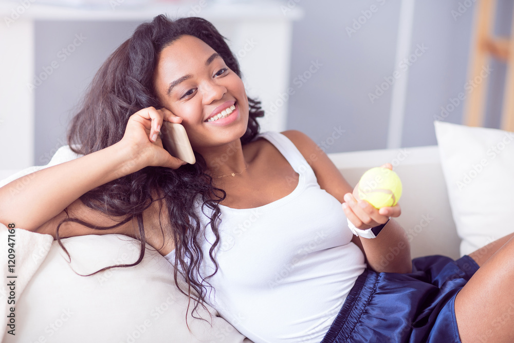 Delighted smiling woman talking on cell phone