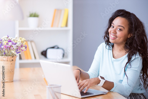 Joyful smiling woman using laptop