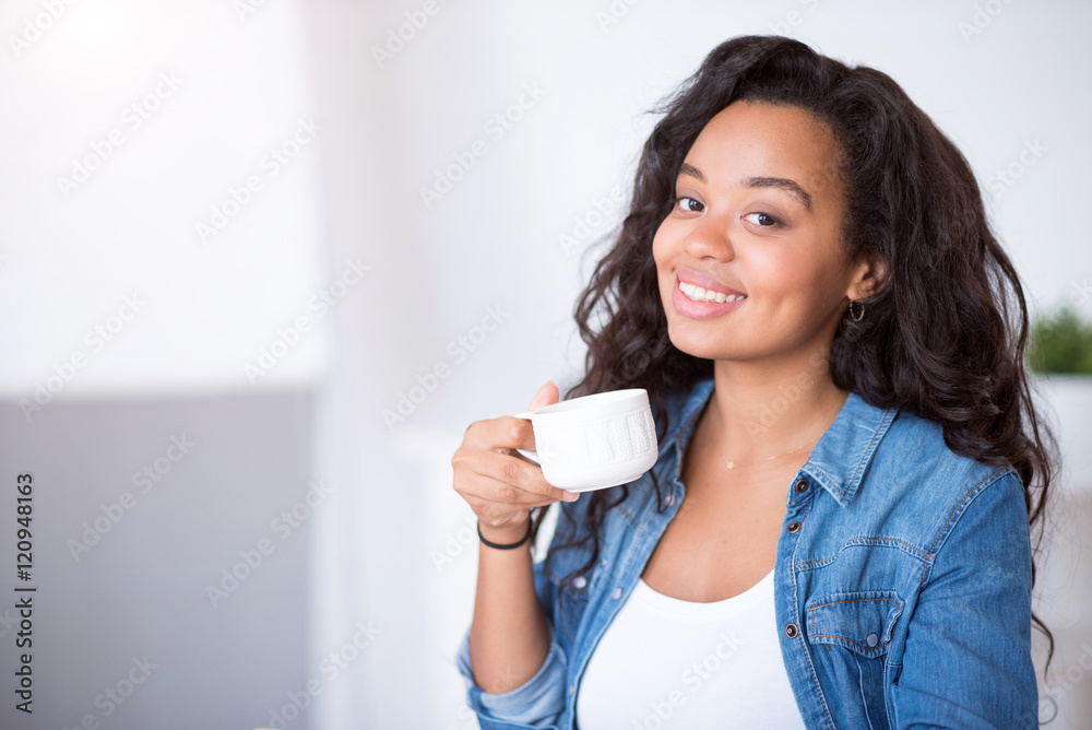 Cheerful smiling woman drinking coffee Cheerful smiling woman drinking coffee