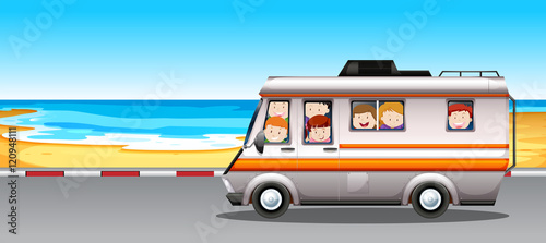 Children riding in camper van to the beach