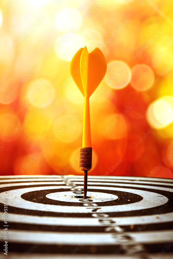 Fototapeta premium target dart with arrow over blurred bokeh background ,metaphor to target marketing or target arrow concept.