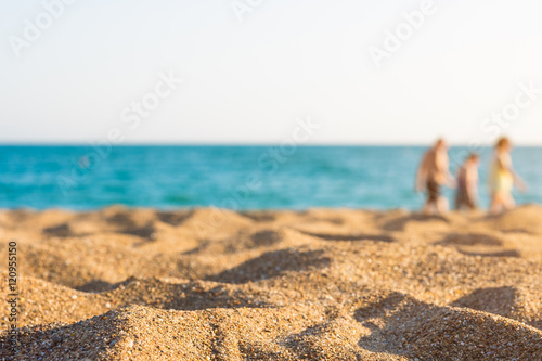 Fototapeta Naklejka Na Ścianę i Meble -  sandy beach and people walking at the seashore