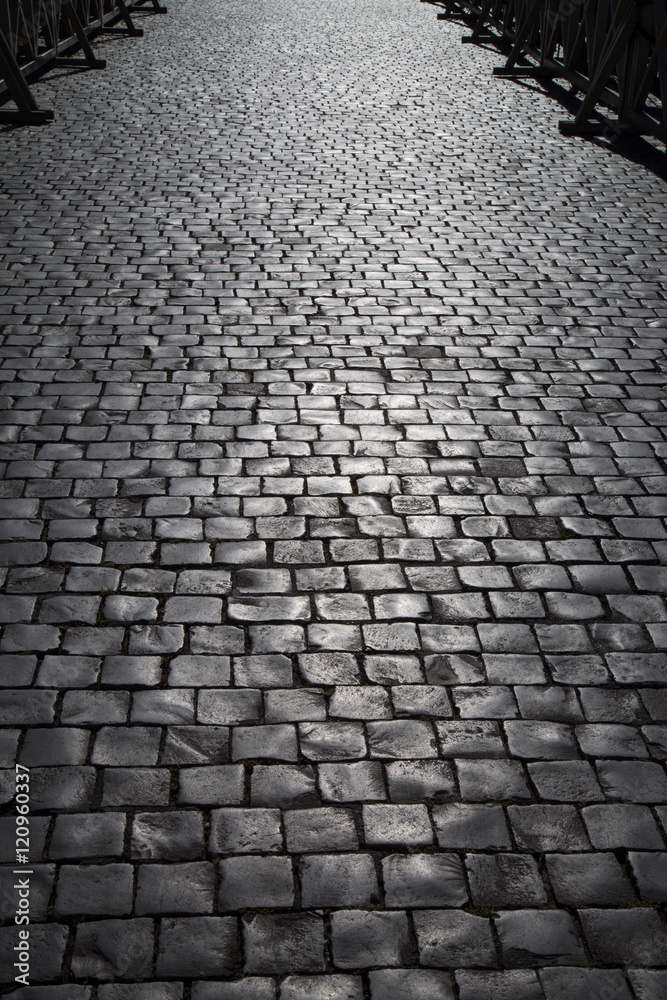 Texture of old cobblestone. City street.