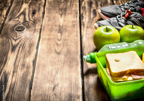 Sandwiches , fruit ,milkshake and sports sneakers