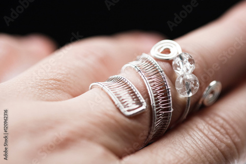 Silver jewels with colorful precious stones and light grey background 