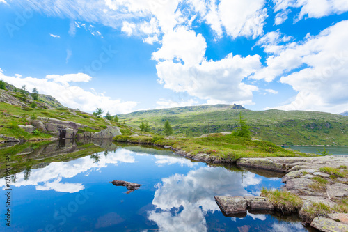 Italian mountain panorama, clouds reflected on alpine lake © elleonzebon
