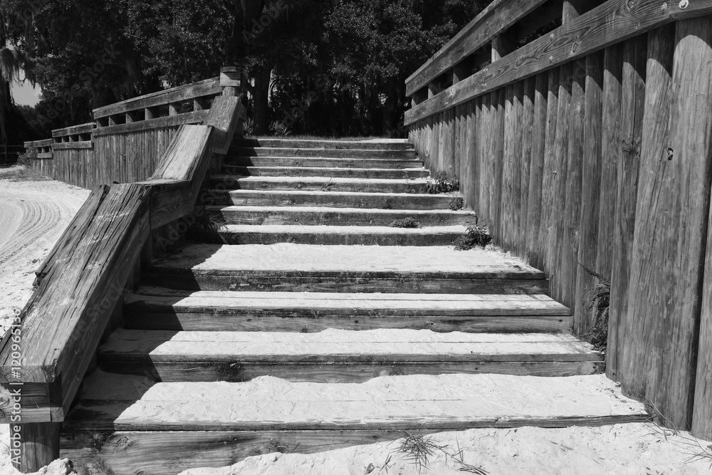 Sandy wooden stairway leaving a beach in Florida.
Sandy wooden stairway leaving a beach in Florida.