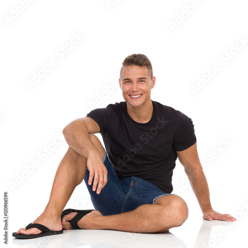 Smiling Man Sitting On A Floor And Resting