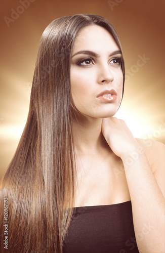 Beautiful young girl with long hair on color background. Beauty concept.