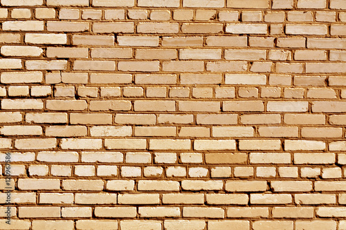 Weathered orange brick wall texture.