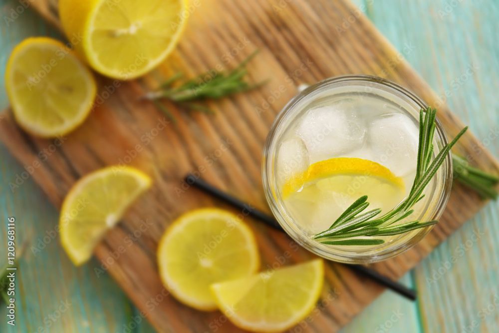 Cold fresh cocktail with lemon on cutting board Cold fresh cocktail with lemon on cutting board