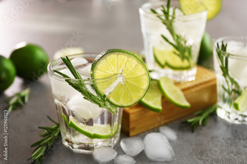 Cold fresh cocktails with lime on table