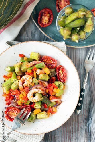 Vegetable stew with okra and shrimps in rustic composition – view from above