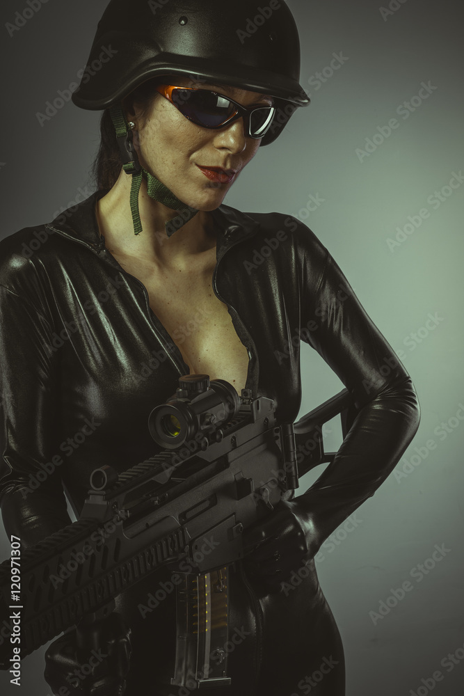 Brunette woman with enormous bulletproof vest and gun Brunette woman with enormous bulletproof vest and gun