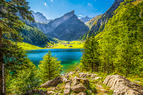 Tourquise clear Seealpsee with the Swiss Alps (mountain Santis) in the background, Appenzeller Land, Switzerland photo