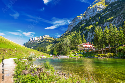 Tourquise clear Seealpsee with the Swiss Alps (mountain Santis) in the background, Appenzeller Land, Switzerland photo