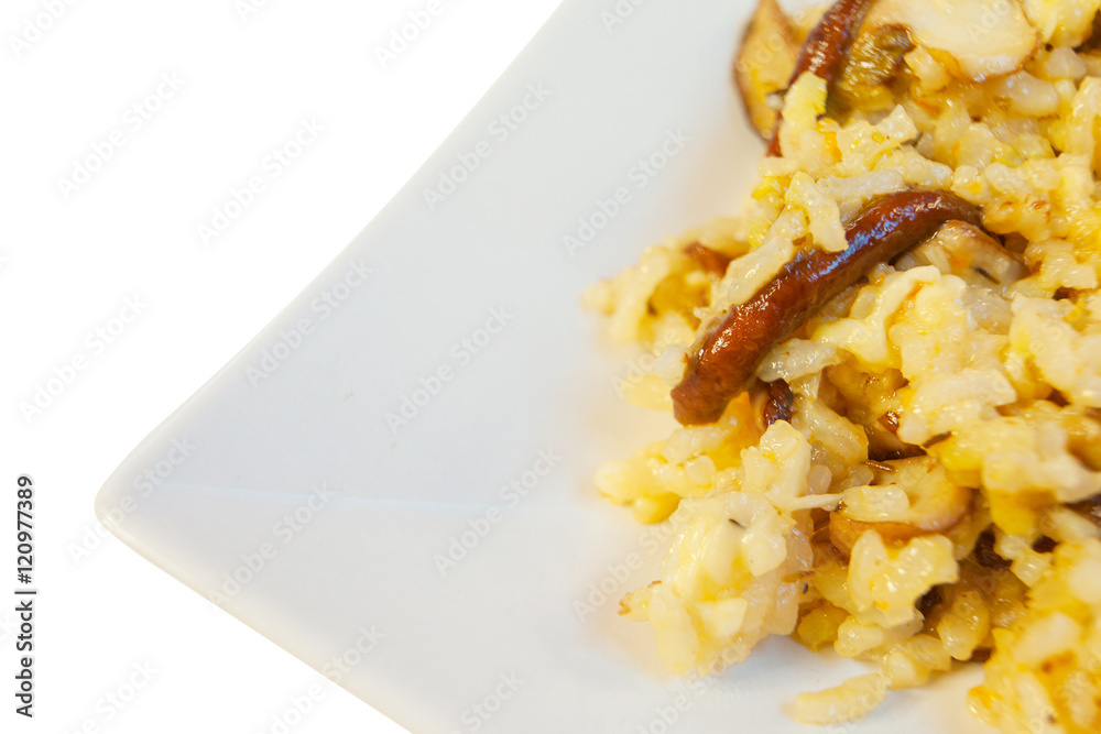  hot risotto with mushrooms on white plate on white background