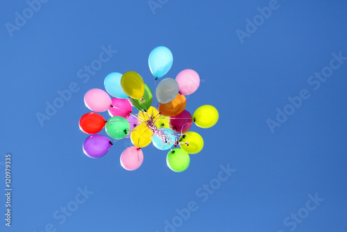 multicolored balloons flying in the blue sky