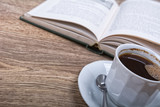 A cup of coffee with a book