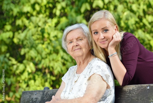 Obraz na płótnie Grandmother and granddaughter. Young woman carefully takes care w salonie